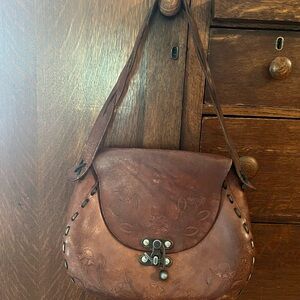 Vintage Brown Shoulder Bag with Saddle Shape and Distressed Finish